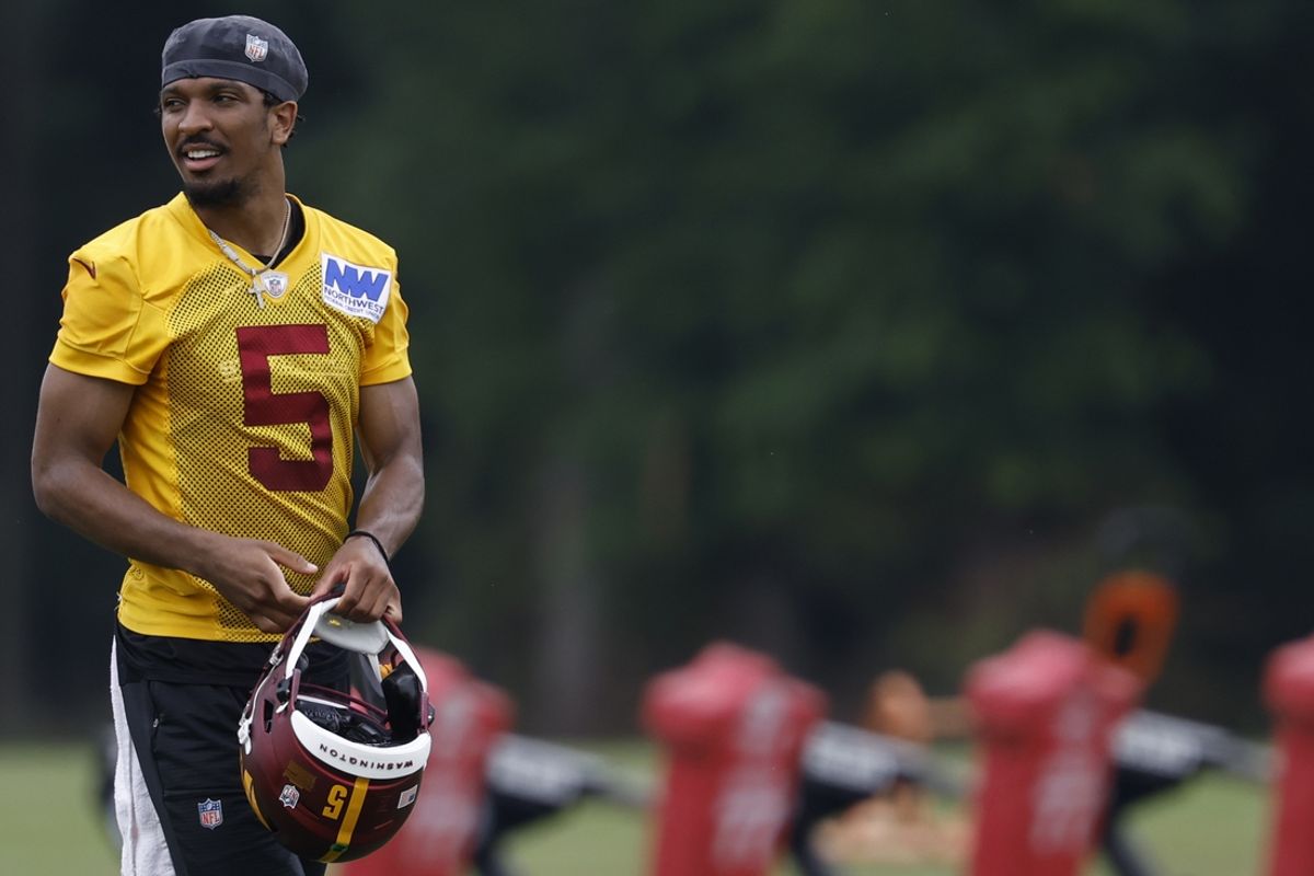 Jun 5, 2024; Ashburn, VA, USA; Washington Commanders quarterback Jayden Daniels (5) stands on the field during OTA workouts at Commanders Park. Mandatory Credit: Geoff Burke-USA TODAY Sports