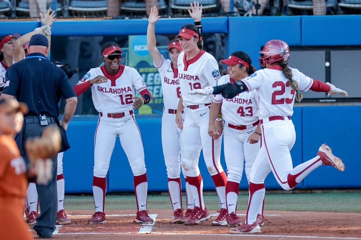 Oklahoma second baseman Tiare Jennings (23) hits a home run in the first inning of the first game of the Women’s College World Series softball championship series between the Oklahoma Sooners and the Texas Longhorns at Devon Park in Oklahoma City on Wednesday, June 5, 2024.