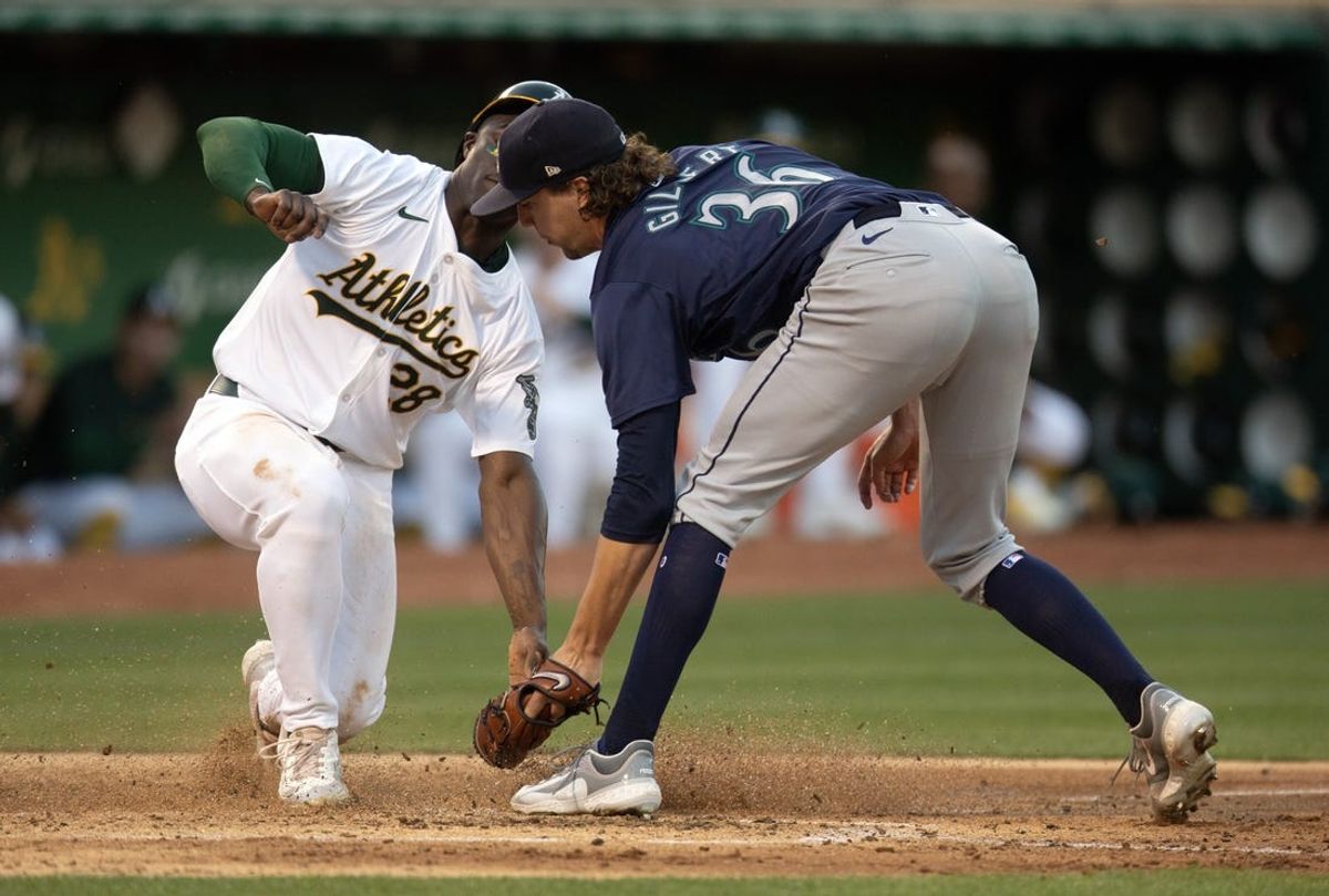 Jun 5, 2024; Oakland, California, USA; Oakland Athletics right fielder Daz Cameron (28) scores from third on a passed ball as Seattle Mariners starting pitcher Logan Gilbert (36) takes the late relay during the fifth inning at Oakland-Alameda County Coliseum. Mandatory Credit: D. Ross Cameron-USA TODAY Sports