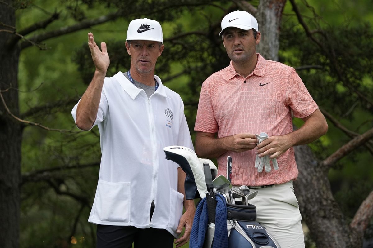 Jun 6, 2024; Dublin, Ohio, USA; Scottie Scheffler (right) and caddie Ted Scott prepared to play a shot from the second tee during the first round of the Memorial Tournament at Muirfield Village Golf Club. Mandatory Credit: Adam Cairns-USA TODAY Sports