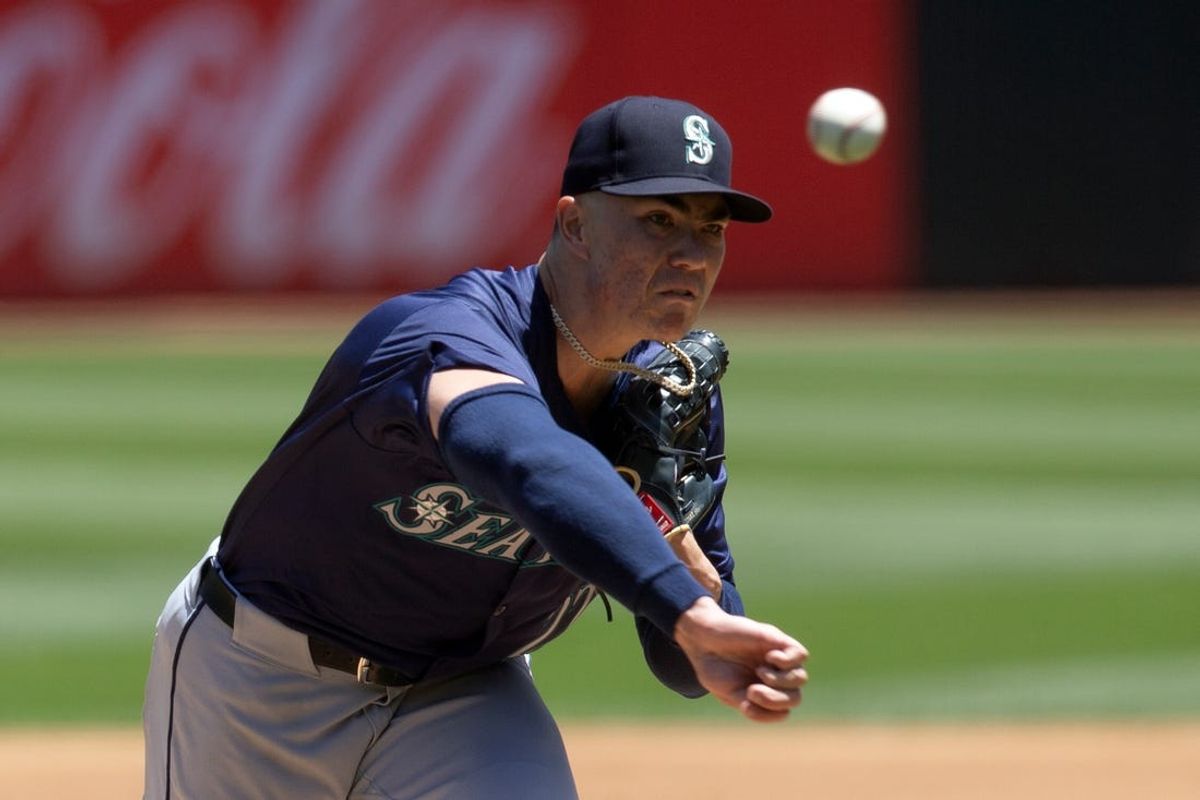 Jun 6, 2024; Oakland, California, USA; Seattle Mariners starting pitcher Bryan Woo (22) delivers a pitch against the Oakland Athletics during the first inning at Oakland-Alameda County Coliseum. Mandatory Credit: D. Ross Cameron-USA TODAY Sports