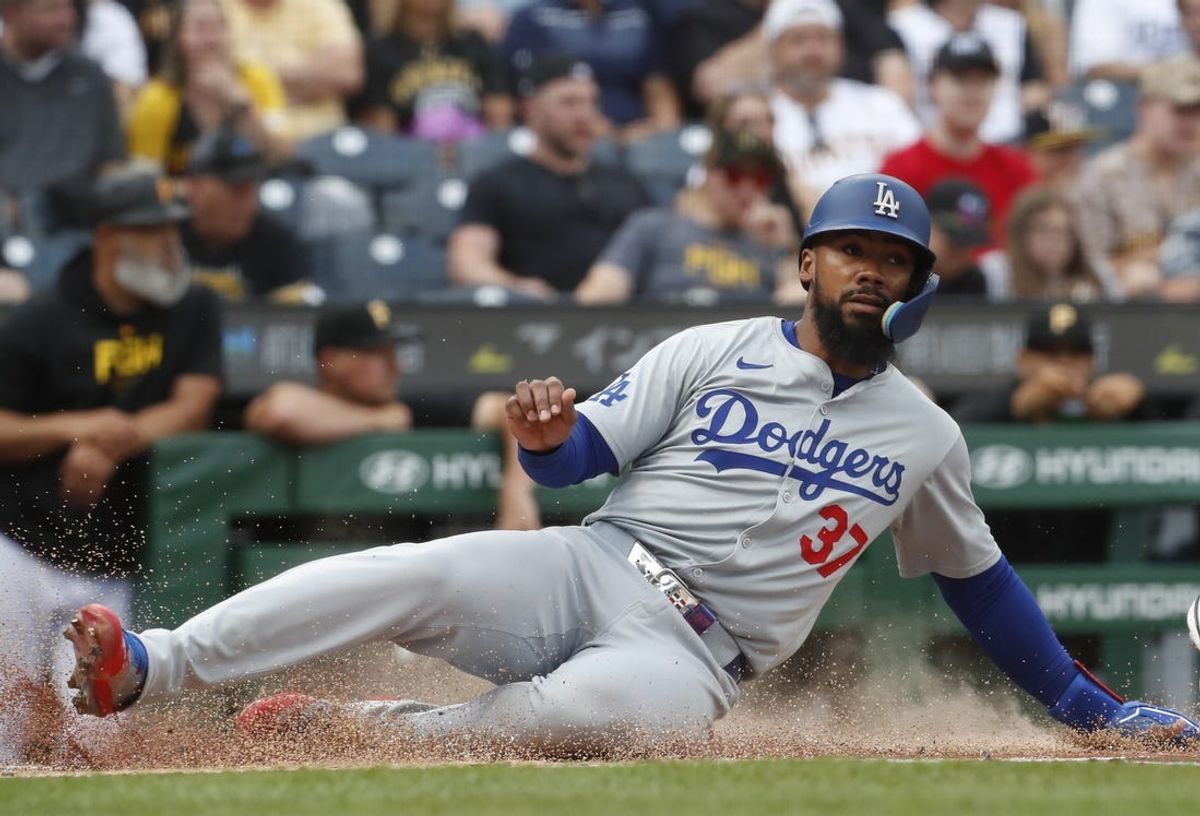 Jun 6, 2024; Pittsburgh, Pennsylvania, USA;  Los Angeles Dodgers right fielder Teoscar Hernández (37) slides across home plate to score a run against the Pittsburgh Pirates during the first inning at PNC Park. Mandatory Credit: Charles LeClaire-USA TODAY Sports