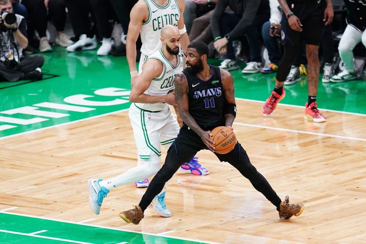 Jun 6, 2024; Boston, Massachusetts, USA; Dallas Mavericks guard Kyrie Irving (11) controls the ball against Boston Celtics guard Derrick White (9) in the second quarter during game one of the 2024 NBA Finals at TD Garden. Mandatory Credit: David Butler II-USA TODAY Sports