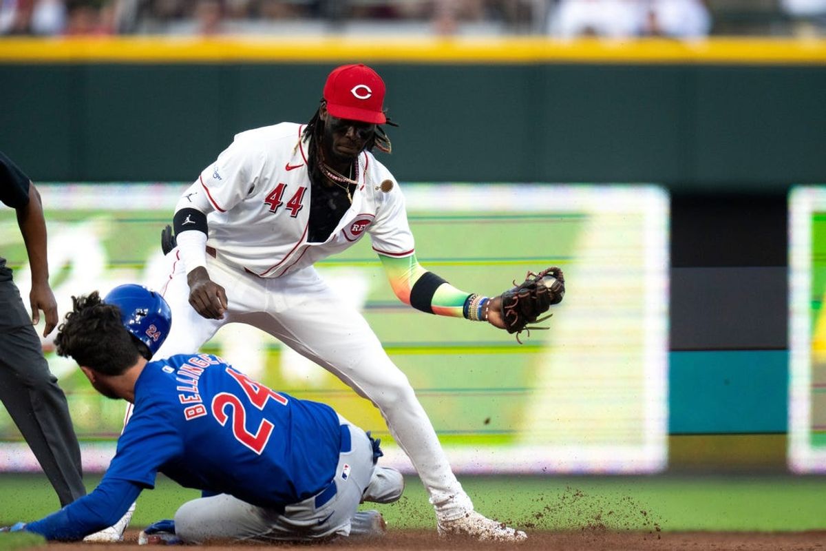 Cincinnati Reds shortstop Elly De La Cruz (44) receives the throw from right field as Chicago Cubs first baseman Cody Bellinger (24) slides into second for a double in the sixth inning of the MLB game between the Cincinnati Reds and the Chicago Cubs at Great American Ball Park in Cincinnati on Thursday, June 6, 2024.