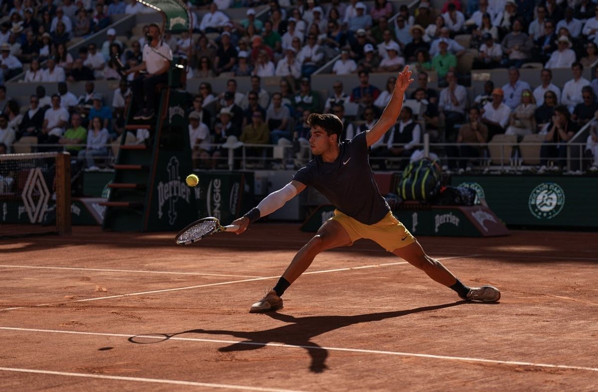 Jun 7, 2024; Paris, France; Carlos Alcaraz of Spain returns a shot during his match against Jannik Sinner of Italy on day 13 of Roland Garros at Stade Roland Garros. Mandatory Credit: Susan Mullane-Imagn Images