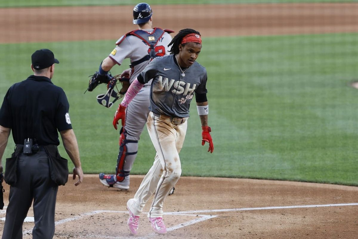 Jun 7, 2024; Washington, District of Columbia, USA; Washington Nationals shortstop CJ Abrams (5) scores a run after a throwing error by Atlanta Braves catcher Sean Murphy (12) during the fourth inning at Nationals Park. Mandatory Credit: Geoff Burke-USA TODAY Sports