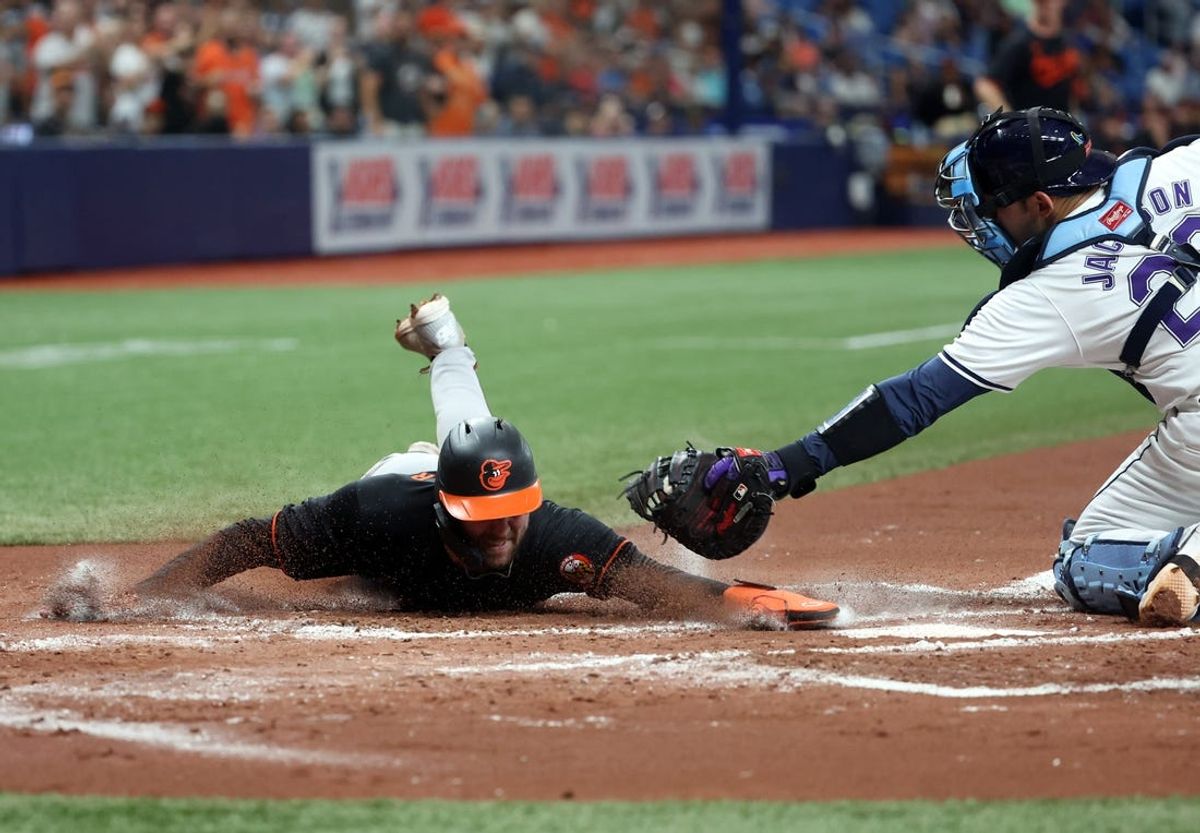 Jun 7, 2024; St. Petersburg, Florida, USA; Baltimore Orioles outfielder Colton Cowser (17) slides home safe as Tampa Bay Rays catcher Alex Jackson (28) attempted to tag him out during the second inning at Tropicana Field. Mandatory Credit: Kim Klement Neitzel-USA TODAY Sports