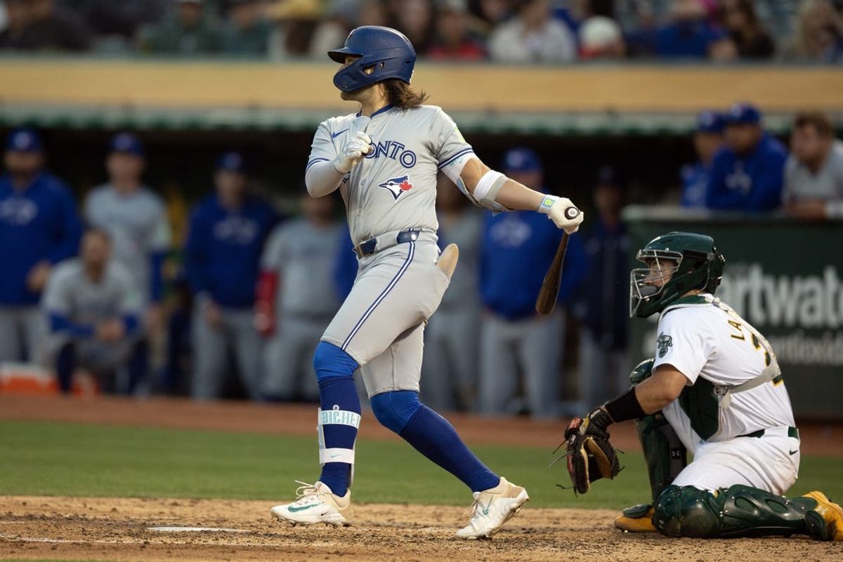 Jun 7, 2024; Oakland, California, USA; Toronto Blue Jays shortstop Bo Bichette (11) follows the flight of his RBI single against the Oakland Athletics during the seventh inning at Oakland-Alameda County Coliseum. Mandatory Credit: D. Ross Cameron-USA TODAY Sports