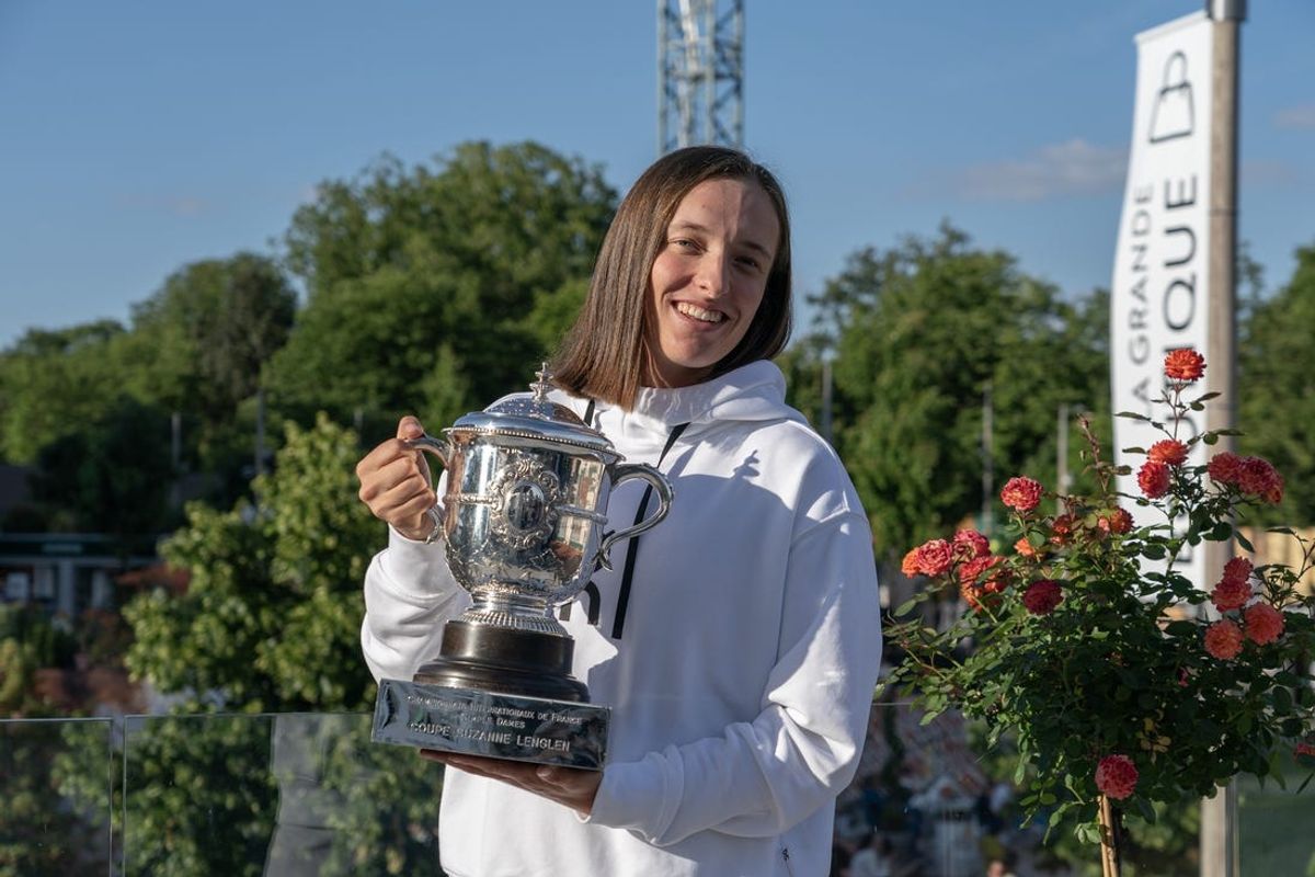 Jun 8, 2024; Paris, France; Iga Swiatek of Poland poses on the Tennis Channel set with the trophy after winning her final match against Jasmine Paolini of Italy on day 14 of Roland Garros at Stade Roland Garros. Mandatory Credit: Susan Mullane-USA TODAY Sports