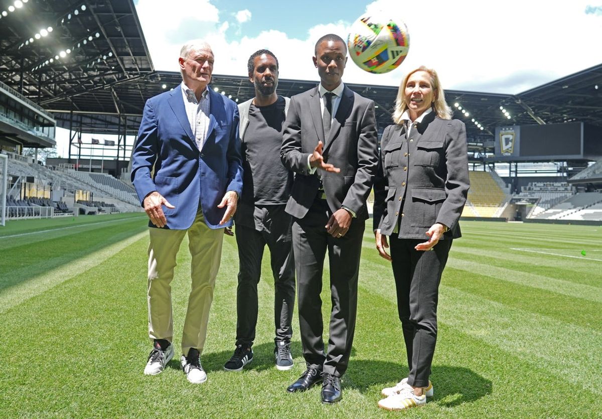 Jun 7, 2024; Columbus, Ohio, USA; The Columbus Crew introduced Issa Tall (third from left) as their new General Manager at Lower.com Field Friday afternoon June 7, 2024. Tall caught the soccer ball tossed their way during a photo opportunity after the news conference. From left is team owner Jimmy Haslam, coach Wilfred Nancy, Tall and owner Dee Haslam.  Mandatory Credit: Doral Chenoweth-Imagn Images
