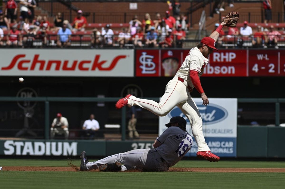 Jun 8, 2024; St. Louis, Missouri, USA; Colorado Rockies’ Charlie Blackmon (19) slides as  St. Louis Cardinals second baseman Nolan Gorman (16) leaps for the ball during the first inning at Busch Stadium. Mandatory Credit: Jeff Le-USA TODAY Sports