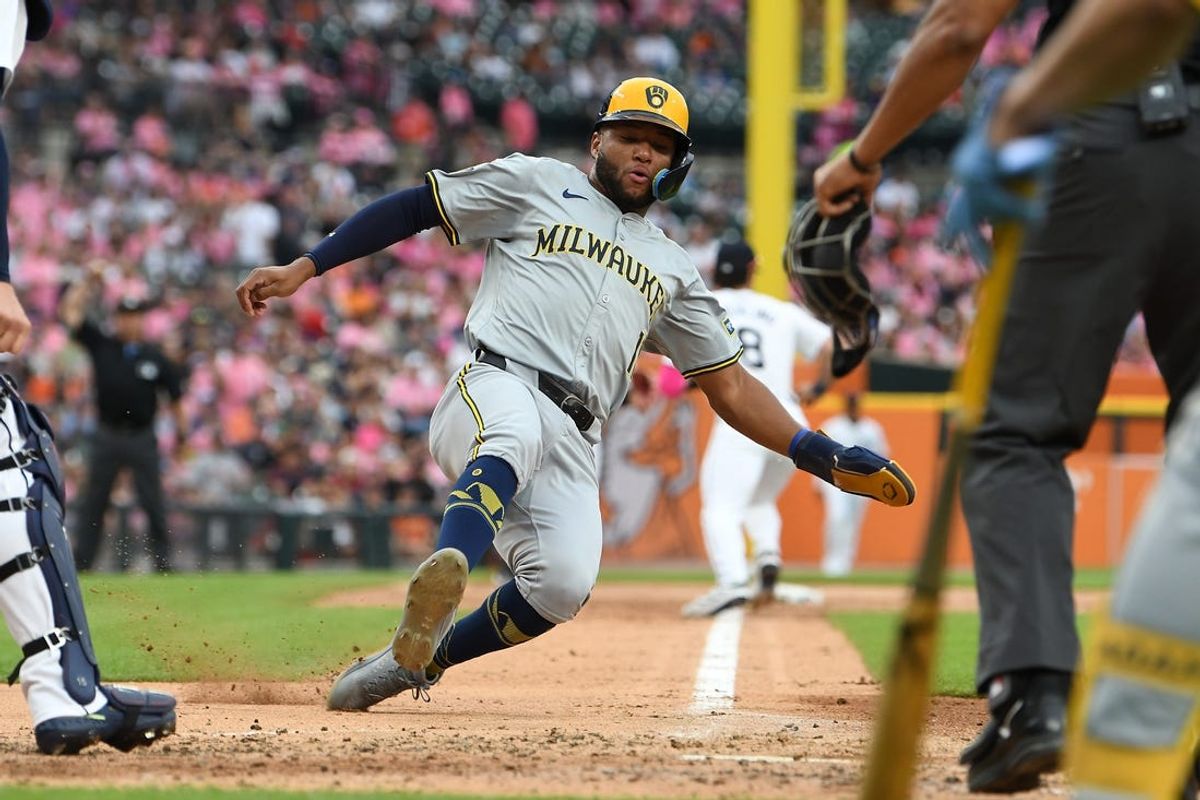 Jun 8, 2024; Detroit, Michigan, USA;  Milwaukee Brewers left fielder Jackson Chourio (11) slides safely into home plate to score a run against the Detroit Tigers in the third inning at Comerica Park. Mandatory Credit: Lon Horwedel-USA TODAY Sports