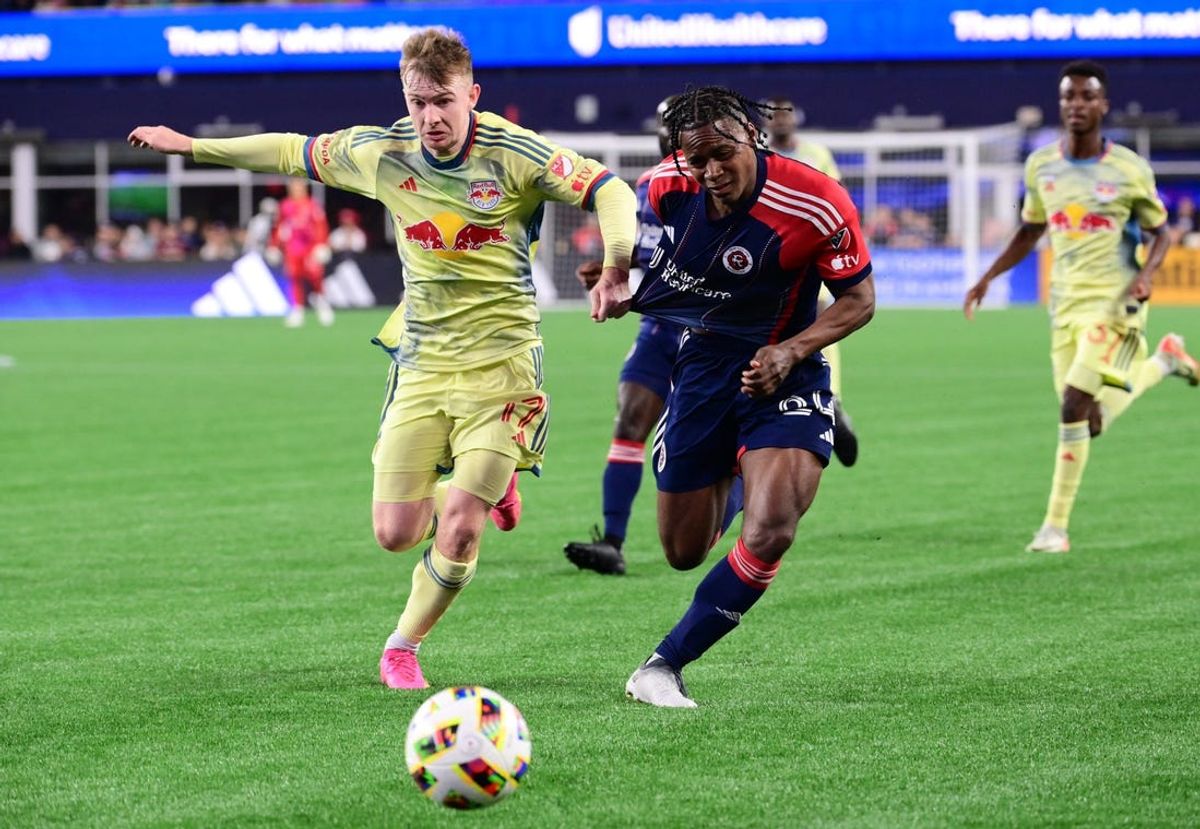 Jun 8, 2024; Foxborough, Massachusetts, USA; New York Red Bulls defender Cameron Harper (17) and New England Revolution defender DeJuan Jones (24) chase a loose ball during the second half at Gillette Stadium. Mandatory Credit: Eric Canha-USA TODAY Sports