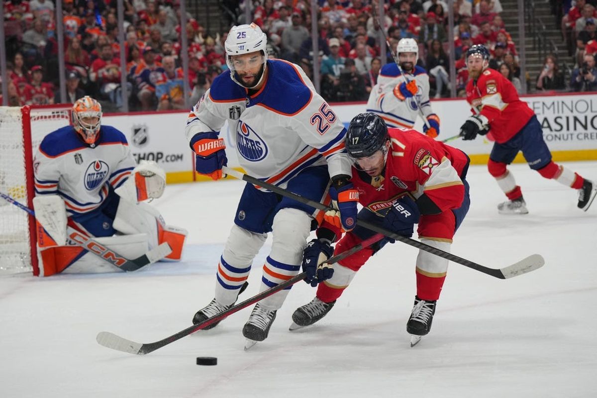 Jun 8, 2024; Sunrise, Florida, USA; Edmonton Oilers defenseman Darnell Nurse (25) defends against Florida Panthers forward Evan Rodrigues (17) during the second period in game one of the 2024 Stanley Cup Final at Amerant Bank Arena. Mandatory Credit: Jim Rassol-USA TODAY Sports