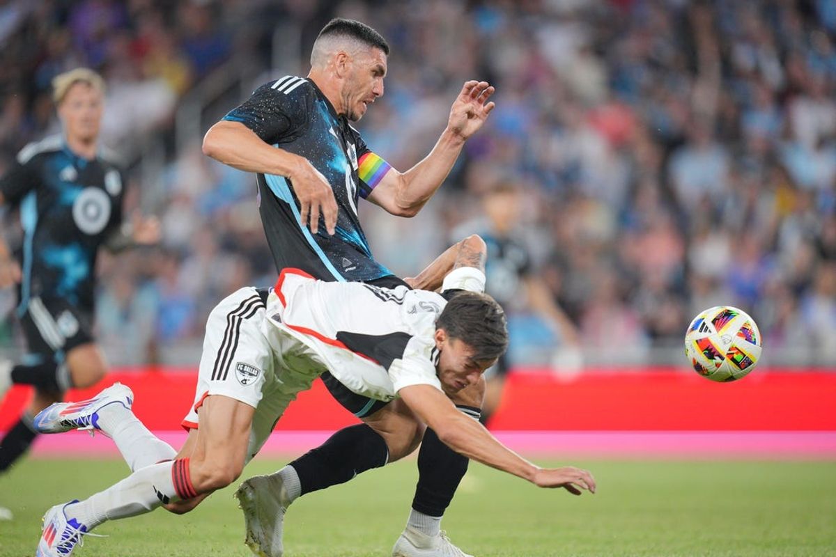 Jun 8, 2024; Saint Paul, Minnesota, USA; Minnesota United defender Michael Boxall (15) tackles FC Dallas forward Petar Musa (9) in the second half at Allianz Field. Mandatory Credit: Brad Rempel-USA TODAY Sports