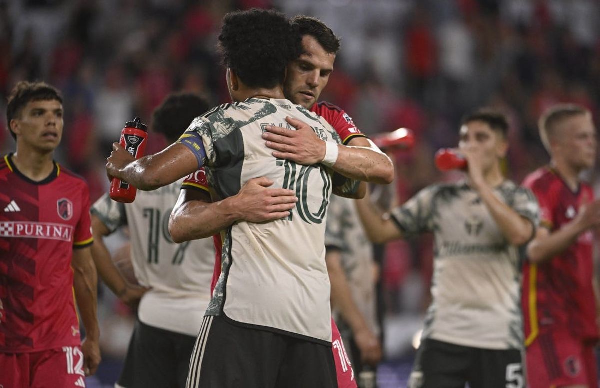 Jun 8, 2024; St. Louis, Missouri, USA; St. Louis CITY SC midfielder Eduard Loewen (10) and Portland Timbers midfielder Evander (10) hug after a game at CITYPARK. Mandatory Credit: Joe Puetz-USA TODAY Sports
