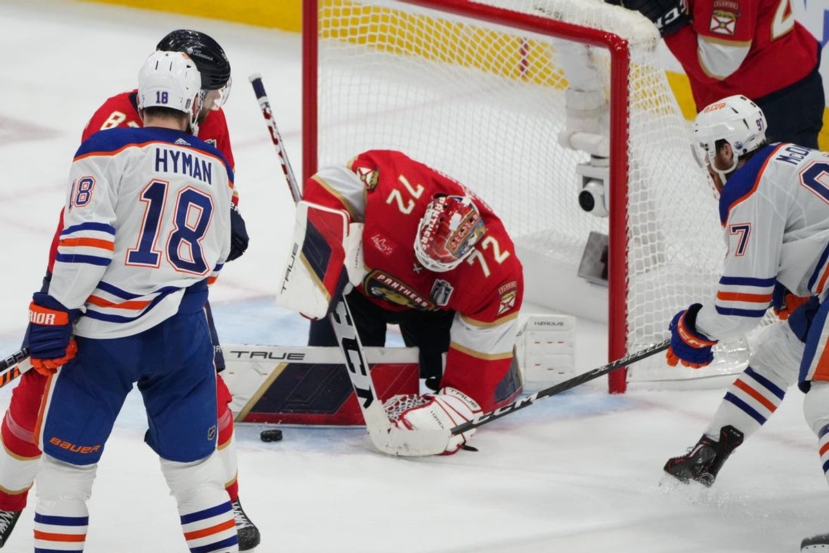 Jun 8, 2024; Sunrise, Florida, USA; Edmonton Oilers forward Connor McDavid (97) reaches for the puck against Florida Panthers goaltender Sergei Bobrovsky (72) during the third period in game one of the 2024 Stanley Cup Final at Amerant Bank Arena. Mandatory Credit: Jim Rassol-USA TODAY Sports