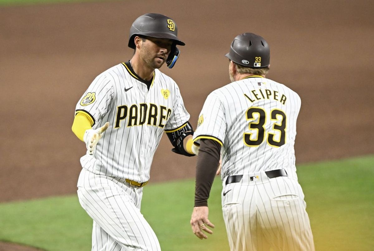 Jun 8, 2024; San Diego, California, USA; San Diego Padres catcher Kyle Higashioka (20) is congratulated by Tim Leiper (33) after he hit a solo home run during the sixth inning against the Arizona Diamondbacks at Petco Park. Mandatory Credit: Denis Poroy-USA TODAY Sports at Petco Park.