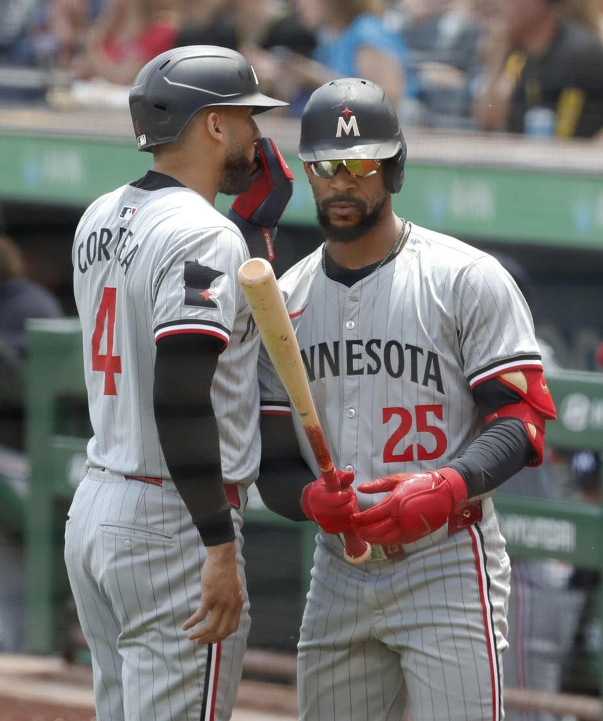 Jun 9, 2024; Pittsburgh, Pennsylvania, USA;  Minnesota Twins shortstop Carlos Correa (4) confers with center fielder Byron Buxton (25) in the on-deck circle against the Pittsburgh Pirates during the first inning at PNC Park. Mandatory Credit: Charles LeClaire-USA TODAY Sports