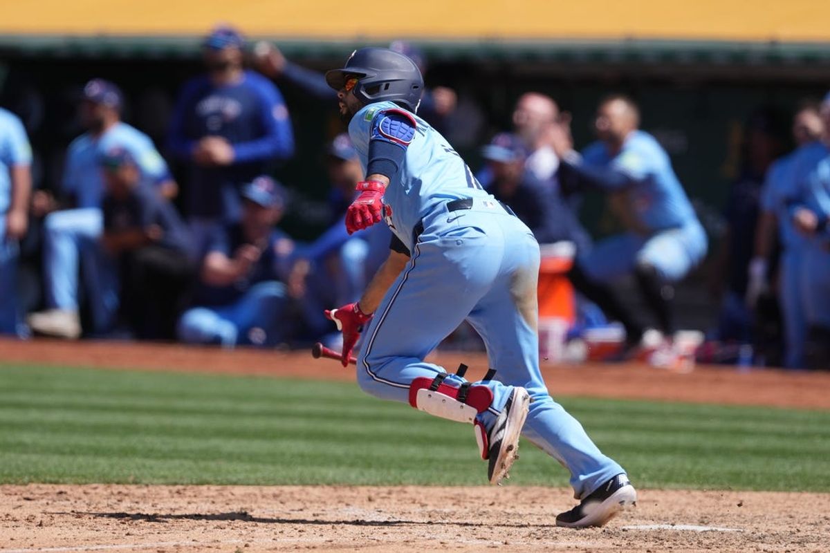 Jun 9, 2024; Oakland, California, USA; Toronto Blue Jays third baseman Isiah Kiner-Falefa (7) runs to first base after hitting an RBI-double against the Oakland Athletics during the tenth inning at Oakland-Alameda County Coliseum. Mandatory Credit: Darren Yamashita-USA TODAY Sports