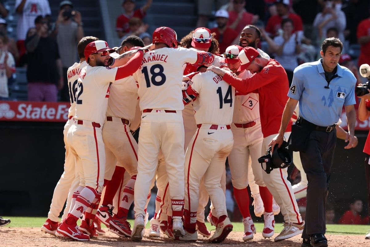 Jun 9, 2024; Anaheim, California, USA;  Los Angeles Angels catcher Logan O'Hoppe (14) celebrates with teammates after hitting a game winning 2-run home run in bottom of the ninth inning against the Houston Astros at Angel Stadium. Mandatory Credit: Kiyoshi Mio-USA TODAY Sports
