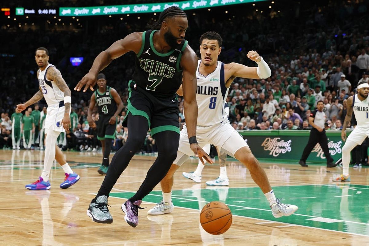 Jun 9, 2024; Boston, Massachusetts, USA; Boston Celtics guard Jaylen Brown (7) dribbles the ball against Dallas Mavericks guard Josh Green (8) during the third quarter in game two of the 2024 NBA Finals at TD Garden. Mandatory Credit: Peter Casey-USA TODAY Sports