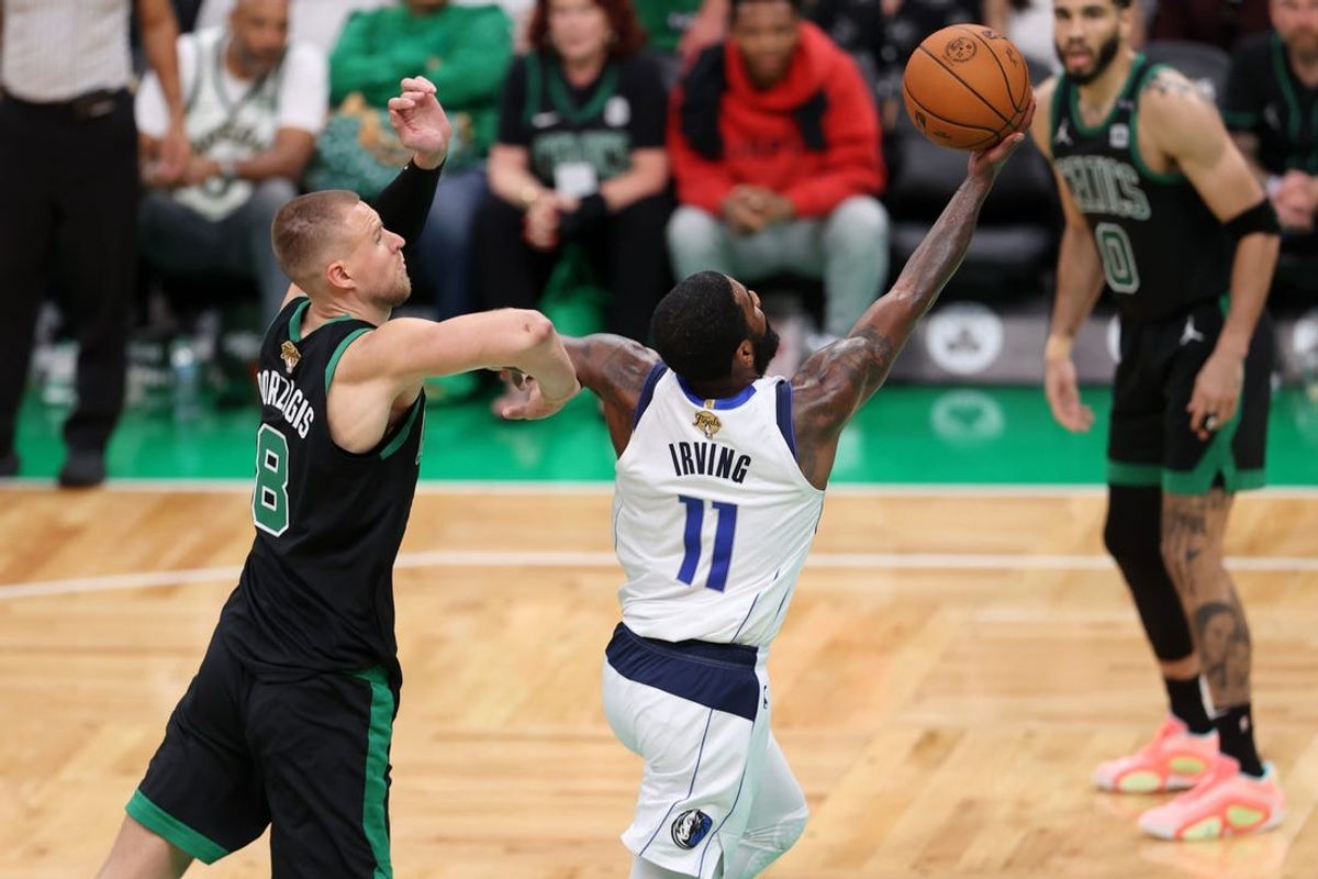 Jun 9, 2024; Boston, Massachusetts, USA; Dallas Mavericks guard Kyrie Irving (11) shoots the ball against Boston Celtics center Kristaps Porzingis (8) during the fourth quarter in game two of the 2024 NBA Finals at TD Garden. Mandatory Credit: Peter Casey-USA TODAY Sports
