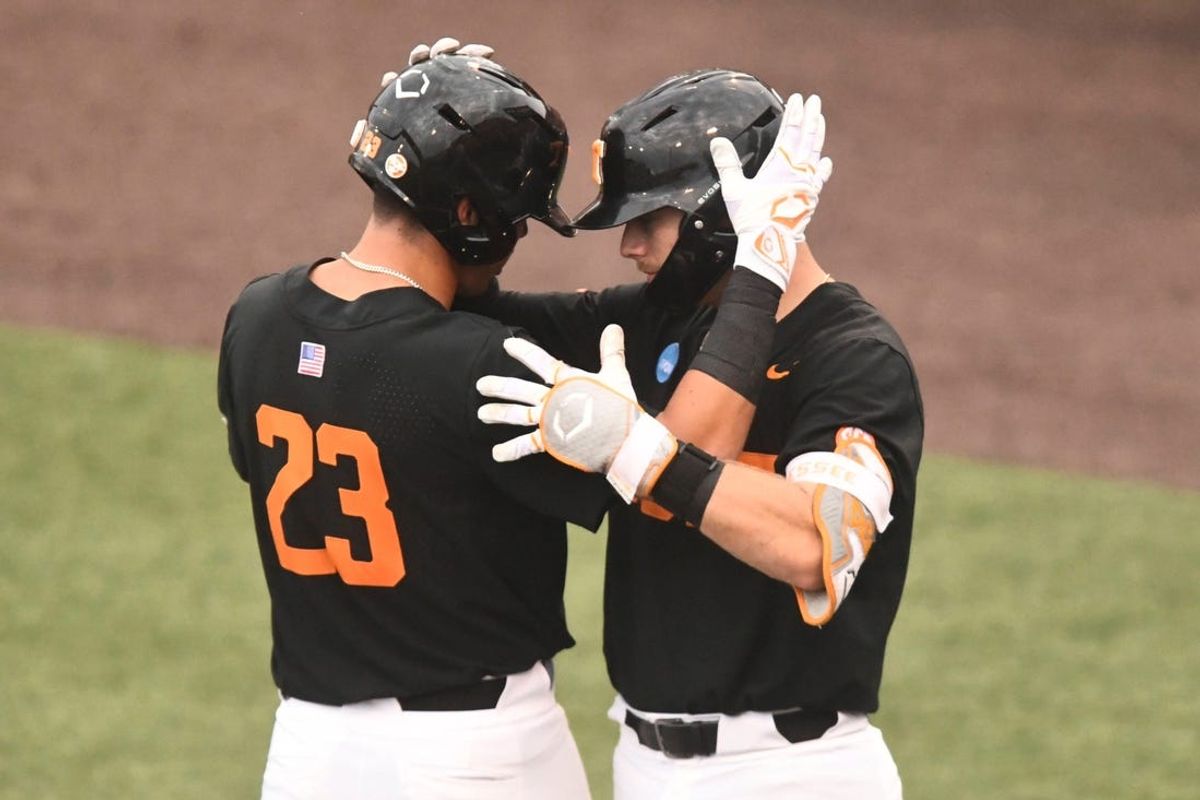 Tennessee's Dean Curley (23) and Cal Stark (10) celebrate Curley's home run against Evansville in the Knoxville Super Regional in the NCAA baseball tournament on Sunday, June 9, 2024 in Knoxville, Tenn.