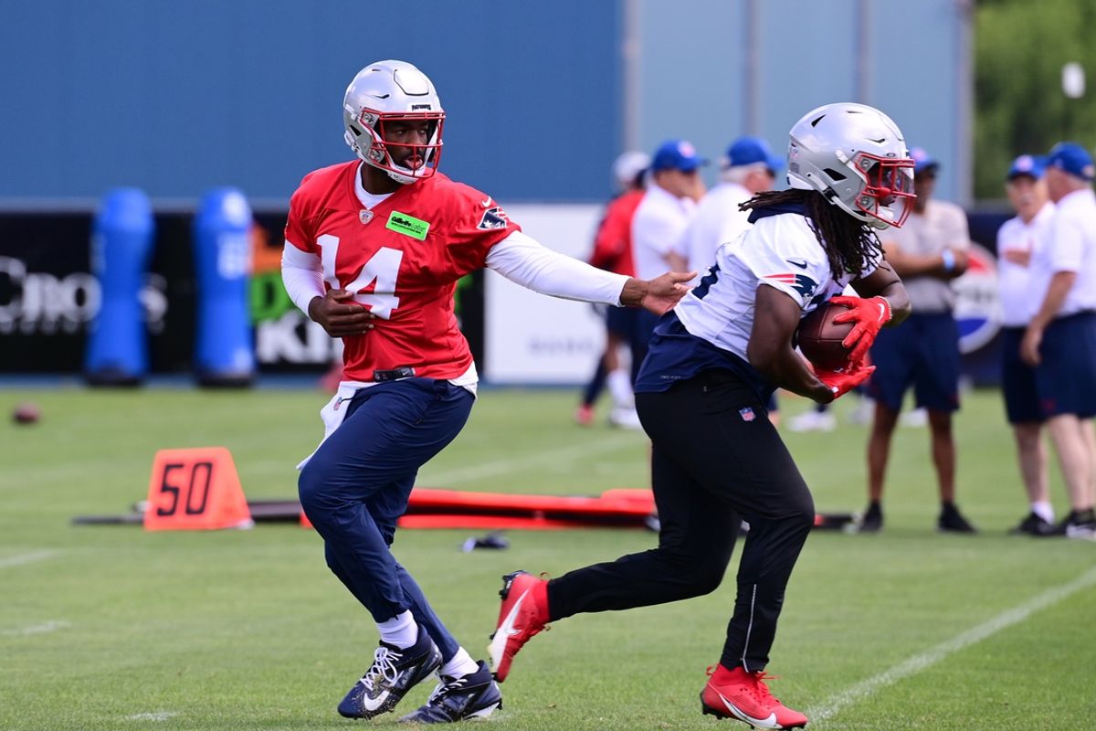 Jun 10, 2024; Foxborough, MA, USA;  New England Patriots quarterback Jacoby Brissett (14) hands the ball to running back Rhamondre Stevenson (38) at minicamp at Gillette Stadium. Mandatory Credit: Eric Canha-USA TODAY Sports