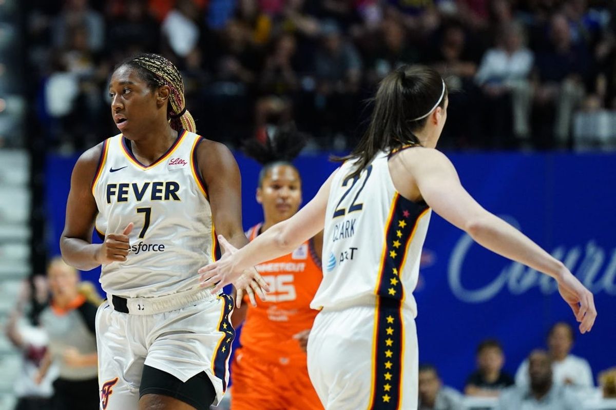 Jun 10, 2024; Uncasville, Connecticut, USA; Indiana Fever forward Aliyah Boston (7) and guard Caitlin Clark (22) react after a basket against the Connecticut Sun in the first quarter at Mohegan Sun Arena. Mandatory Credit: David Butler II-USA TODAY Sports