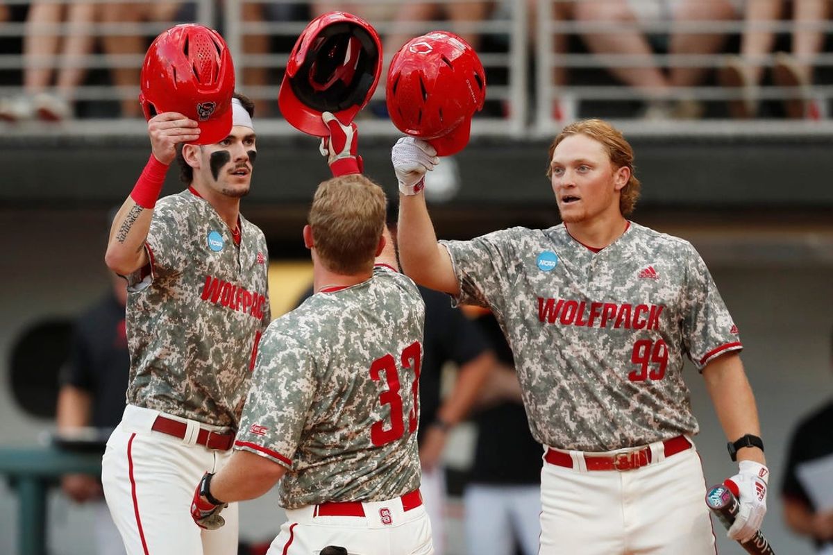 NC State's Garrett Pennington (33) celebrates with his teammates after hitting a home run during Game 3 of the Super NCAA regional at Foley Field on Monday, June 10, 2024 in Athens, Ga.