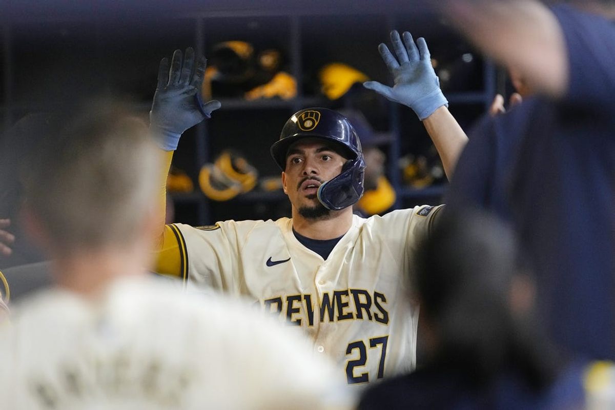 Jun 10, 2024; Milwaukee, Wisconsin, USA;  Milwaukee Brewers shortstop Willy Adames (27) celebrates in the dugout after hitting a home run  during the fourth inning against the Toronto Blue Jays at American Family Field. Mandatory Credit: Jeff Hanisch-USA TODAY Sports