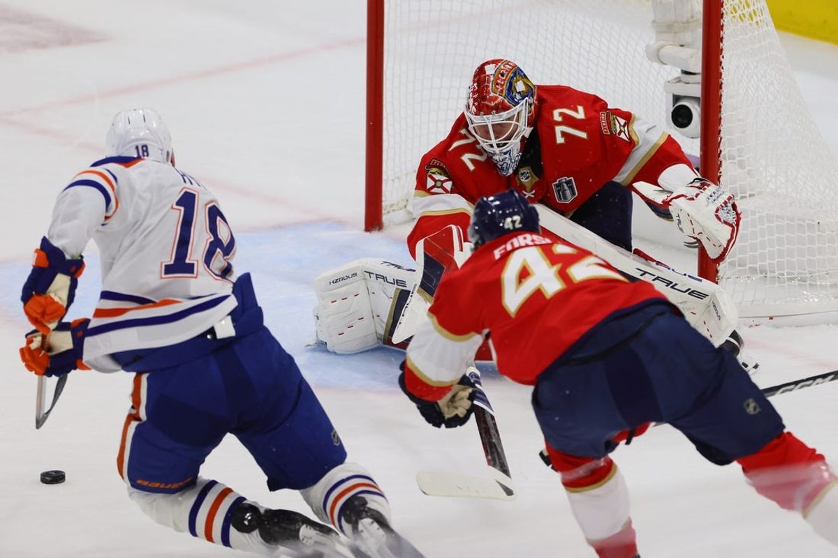 Jun 10, 2024; Sunrise, Florida, USA; Edmonton Oilers forward Zach Hyman (18) moves the puck against Florida Panthers goaltender Sergei Bobrovsky (72) and defenseman Gustav Forsling (42) during the first period in game two of the 2024 Stanley Cup Final at Amerant Bank Arena. Mandatory Credit: Sam Navarro-USA TODAY Sports
