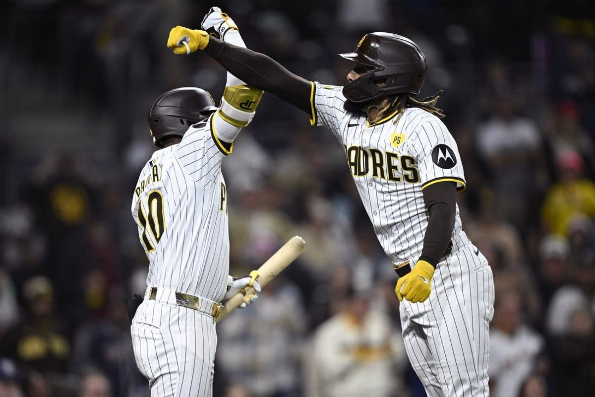 Jun 10, 2024; San Diego, California, USA; San Diego Padres right fielder Fernando Tatis Jr. (right) is congratulated by left fielder Jurickson Profar (10) after hitting a home run against the Oakland Athletics during the fifth inning at Petco Park. Mandatory Credit: Orlando Ramirez-USA TODAY Sports