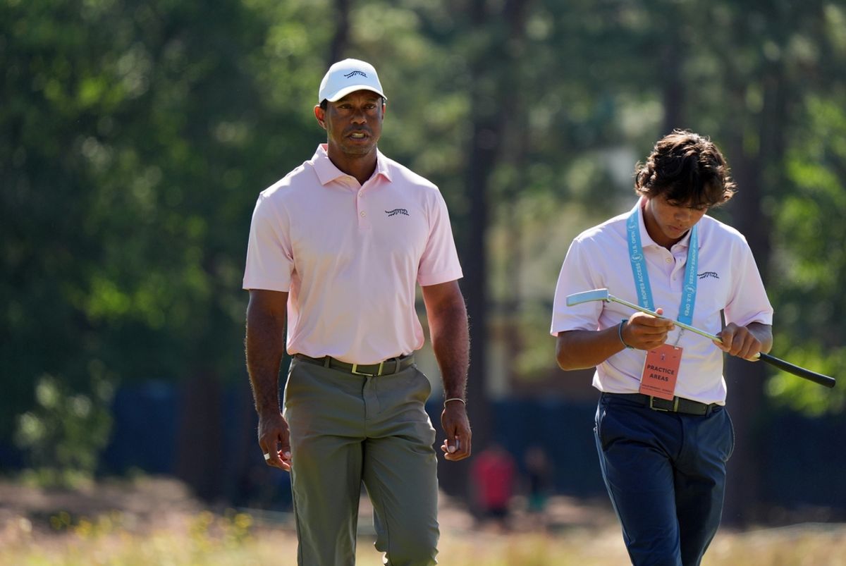 Jun 11, 2024; Pinehurst, North Carolina, USA;  Tiger Woods and his son Charlie Woods walk off the seventh green during a practice round for the U.S. Open golf tournament at Pinehurst No. 2. Mandatory Credit: Katie Goodale-USA TODAY Sports