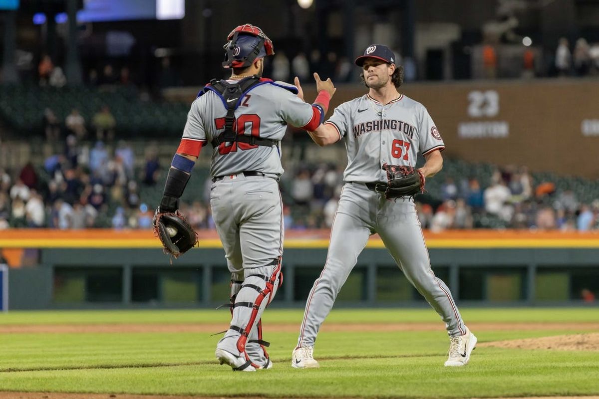 Jun 11, 2024; Detroit, Michigan, USA; Washington Nationals pitcher Kyle Finnegan (67) celebrates the victory over the Detroit Tigers in the tenth inning with catcher Keibert Ruiz (20) at Comerica Park. Mandatory Credit: David Reginek-USA TODAY Sports