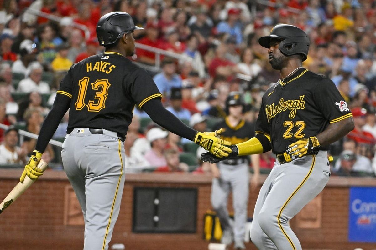 Jun 11, 2024; St. Louis, Missouri, USA;  Pittsburgh Pirates designated hitter Andrew McCutchen (22) is congratulated by third baseman Ke'Bryan Hayes (13) after scoring against the St. Louis Cardinals during the ninth inning at Busch Stadium. Mandatory Credit: Jeff Curry-USA TODAY Sports