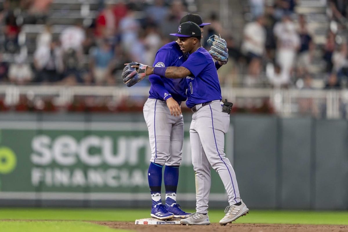 Jun 11, 2024; Minneapolis, Minnesota, USA; Colorado Rockies shortstop Ezequiel Tovar (14) and second baseman Adael Amador (1) celebrate after defeating the Minnesota Twins at Target Field. Mandatory Credit: Jesse Johnson-USA TODAY Sports