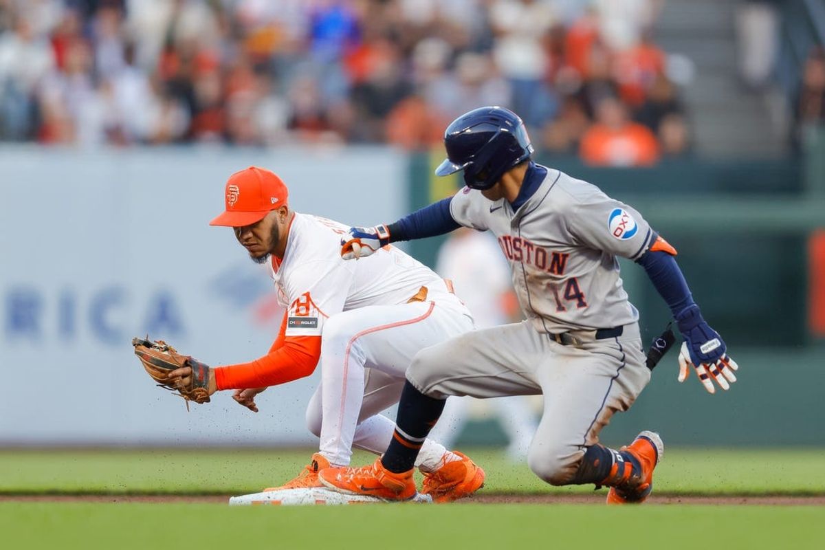 Jun 11, 2024; San Francisco, California, USA; Houston Astros outfielder Mauricio Dubón (14) slides into second base after hitting a double during the fifth inning against the San Francisco Giants at Oracle Park. Mandatory Credit: Sergio Estrada-USA TODAY Sports