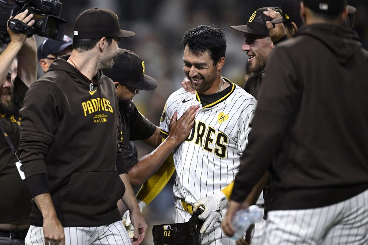 Jun 11, 2024; San Diego, California, USA; San Diego Padres catcher Kyle Higashioka (20) is congratulated after hitting a walk-off home run against the Oakland Athletics at Petco Park. Mandatory Credit: Orlando Ramirez-USA TODAY Sports