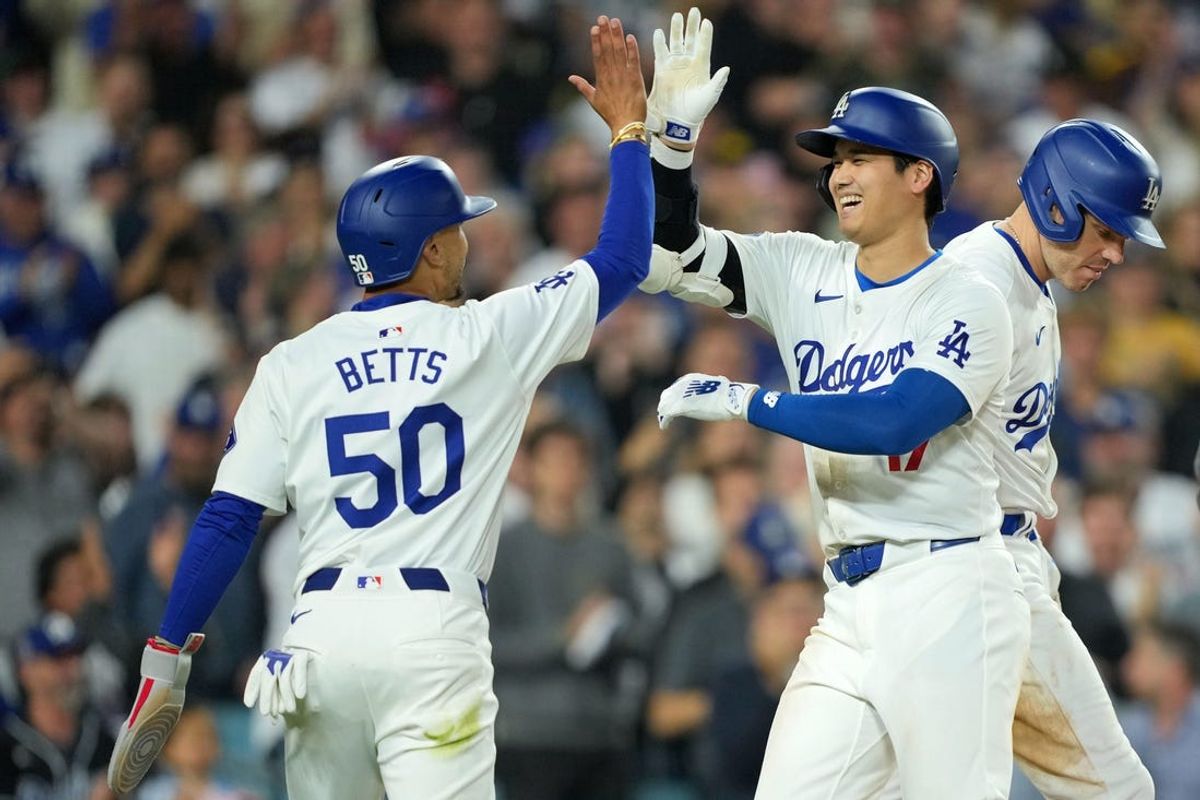 Jun 11, 2024; Los Angeles, California, USA; Los Angeles Dodgers designated hitter Shohei Ohtani (17) celebrates at home plate with shortstop Mookie Betts (50) after hitting a two-run home run in the sixth inning against the Texas Rangers at Dodger Stadium. at Dodger Stadium. Mandatory Credit: Kirby Lee-USA TODAY Sports