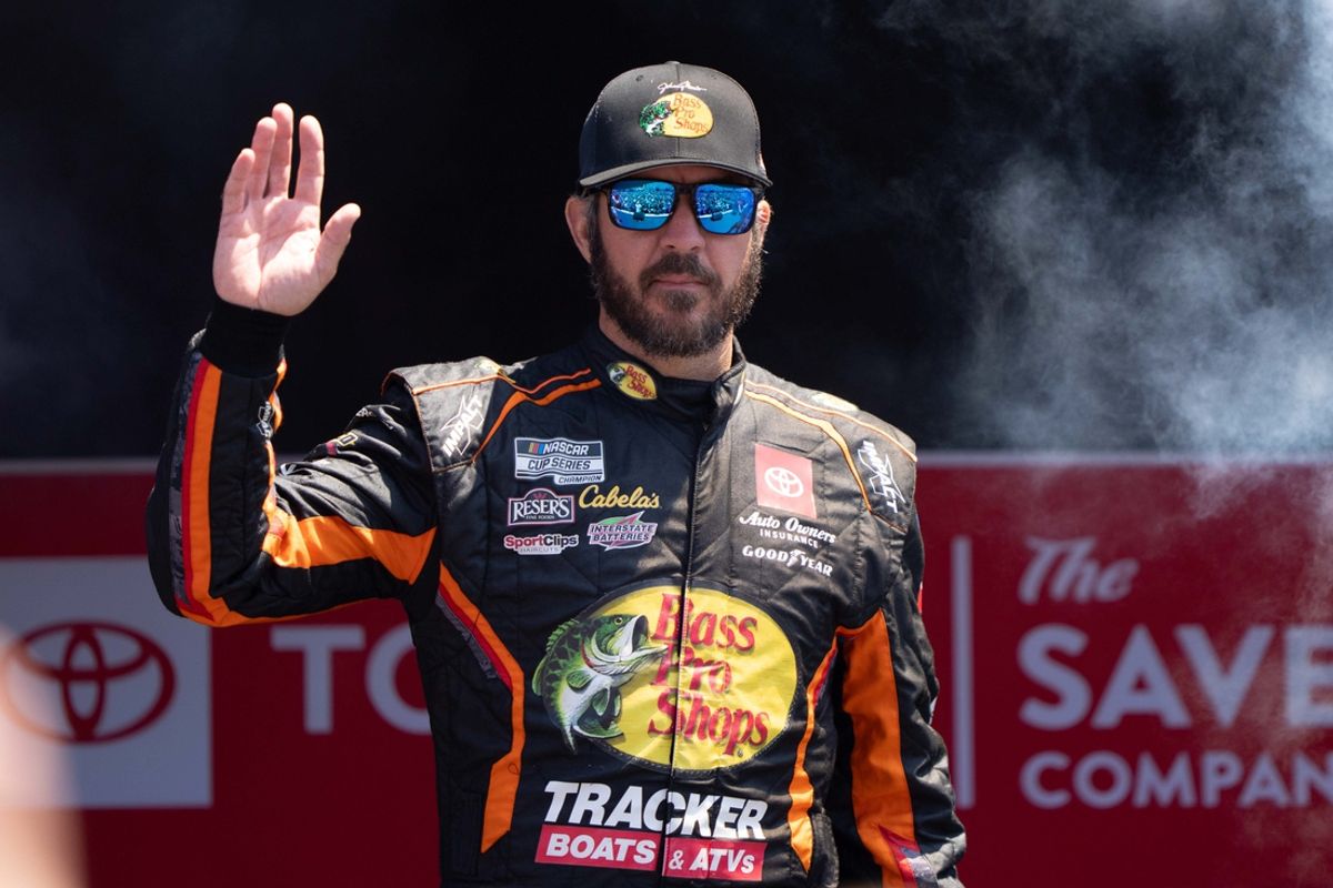 Jun 9, 2024; Sonoma, California, USA;  NASCAR Cup Series driver Martin Truex Jr. (19) waves as he gets introduced to fans before the start of the Toyota / Save Mart 350 at Sonoma Raceway. Mandatory Credit: Stan Szeto-Imagn Images