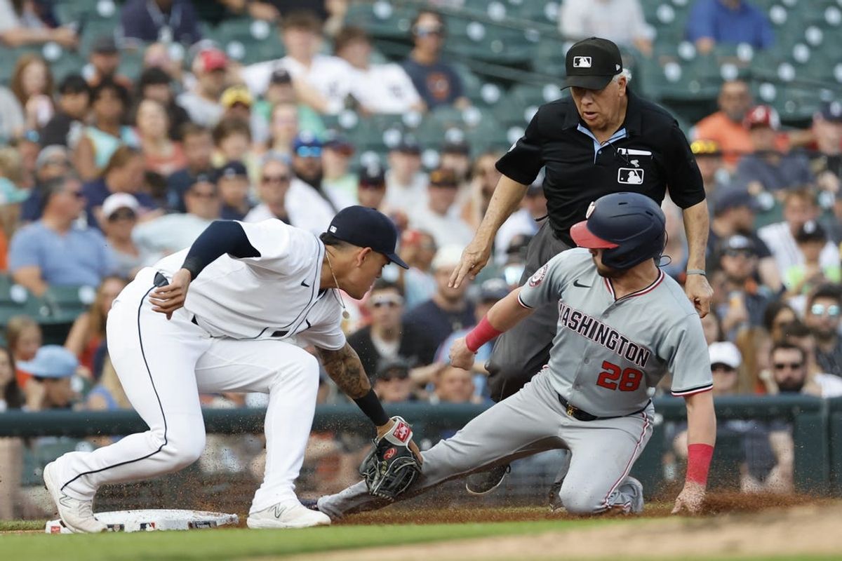 Jun 12, 2024; Detroit, Michigan, USA;  Detroit Tigers third baseman Gio Urshela (13) tags Washington Nationals right fielder Lane Thomas (28) out trying to steal third in the third inning at Comerica Park. Mandatory Credit: Rick Osentoski-USA TODAY Sports