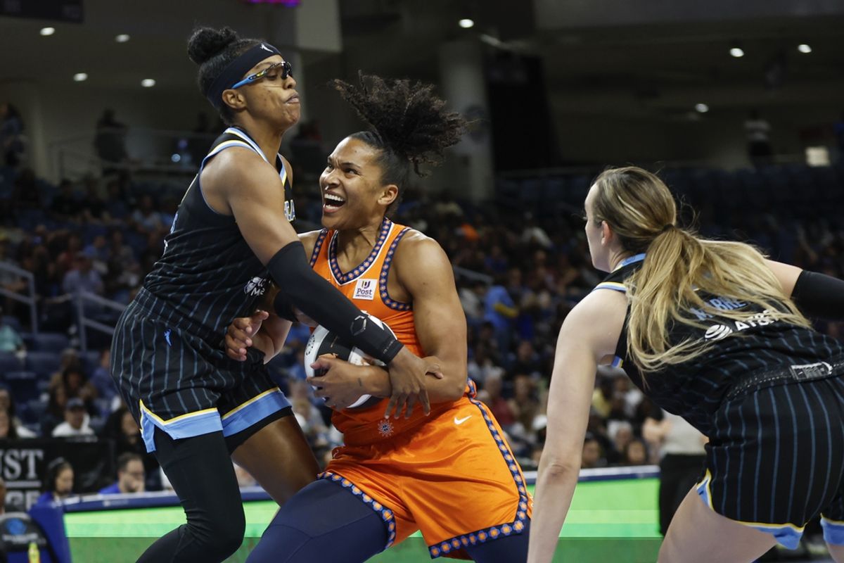 Jun 12, 2024; Chicago, Illinois, USA; Connecticut Sun forward Alyssa Thomas (25) drives to the basket against Chicago Sky guard Diamond DeShields (0) during the first half of a basketball game at Wintrust Arena. Mandatory Credit: Kamil Krzaczynski-Imagn Images