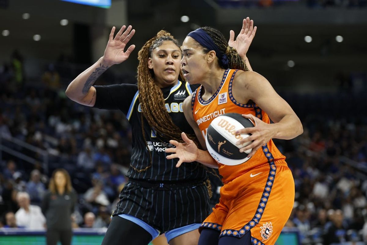 Jun 12, 2024; Chicago, Illinois, USA; Connecticut Sun forward Brionna Jones (42) drives to the basket against Chicago Sky center Kamilla Cardoso (10) during the first half of a basketball game at Wintrust Arena. Mandatory Credit: Kamil Krzaczynski-USA TODAY Sports