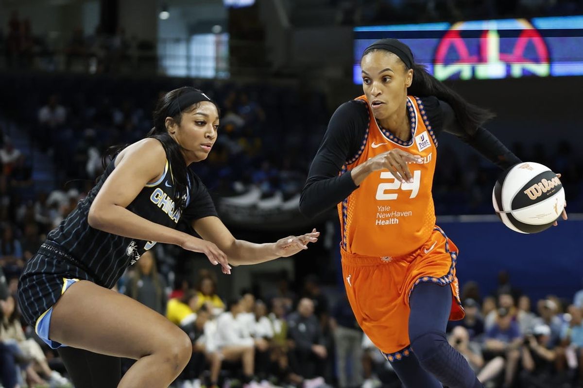 Jun 12, 2024; Chicago, Illinois, USA; Connecticut Sun forward DeWanna Bonner (24) drives to the basket against Chicago Sky forward Angel Reese (5) during the first half of a basketball game at Wintrust Arena. Mandatory Credit: Kamil Krzaczynski-USA TODAY Sports