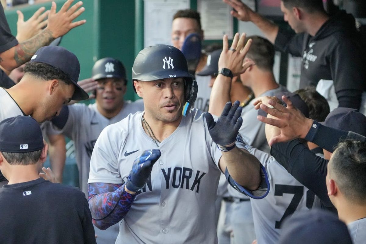 Jun 12, 2024; Kansas City, Missouri, USA; New York Yankees designated hitter Giancarlo Stanton (27) celebrates in the dugout after hitting a two run home run against the Kansas City Royals in the fifth inning at Kauffman Stadium. Mandatory Credit: Denny Medley-USA TODAY Sports