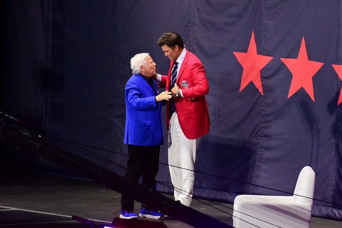 Jun 12, 2024; Foxborough, MA, USA; Team owner Robert Kraft presents Tom Brady with his red jacket during the New England Patriots Hall of Fame induction Ceremony for Tom Brady at Gillette Stadium.  Mandatory Credit: Eric Canha-USA TODAY Sports