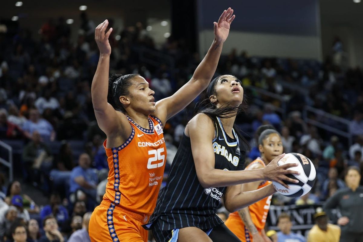 Jun 12, 2024; Chicago, Illinois, USA; Chicago Sky forward Angel Reese (5) goes to the basket against Connecticut Sun forward Alyssa Thomas (25) during the second half of a basketball game at Wintrust Arena. Mandatory Credit: Kamil Krzaczynski-USA TODAY Sports