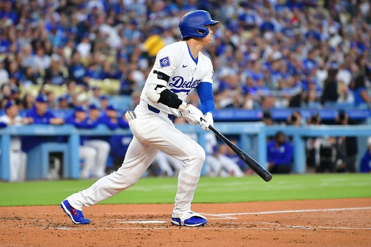 Jun 12, 2024; Los Angeles, California, USA; Los Angeles Dodgers designated hitter Shohei Ohtani (17) runs out a fly ball against the Texas Rangers during the third inning at Dodger Stadium. Mandatory Credit: Gary A. Vasquez-USA TODAY Sports
